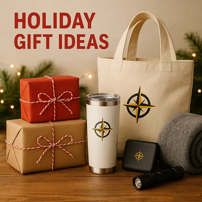 A warm, rustic holiday gift display featuring a beige tote, stainless tumbler, flashlight, and wrapped presents decorated with red and kraft paper. Each gift shows a golden compass logo, symbolizing adventure and thoughtful branding.